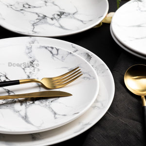 marble plates with gold flatware